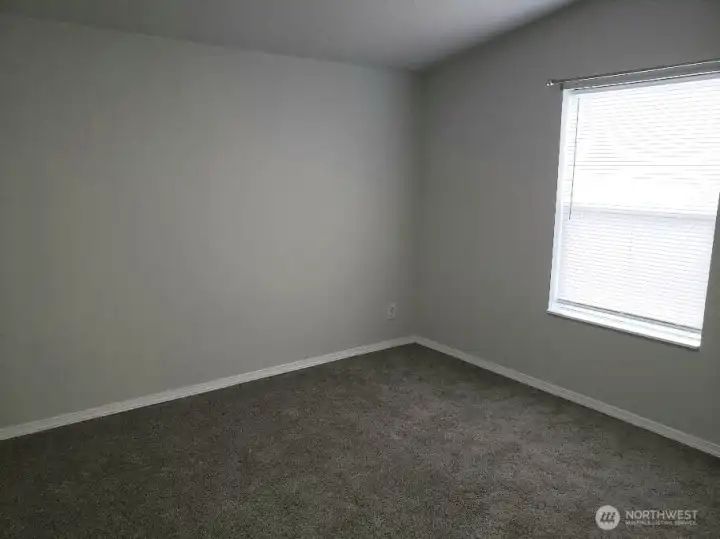 A Picture of the Really a Nice Size Second Bedroom Showing Newer Trim, and Carpe
