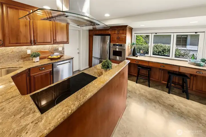 Updated kitchen is built for entertaining with lots of storage & buffet that opens to the outside deck for easy great flow. To the right is the dining room. To the left is the butler's pantry, laundry, and back patio access.
