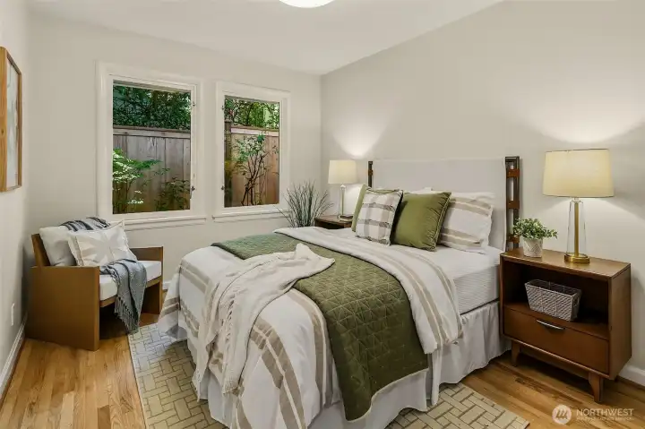 2 of 3 main level bedrooms with hardwood floors.
