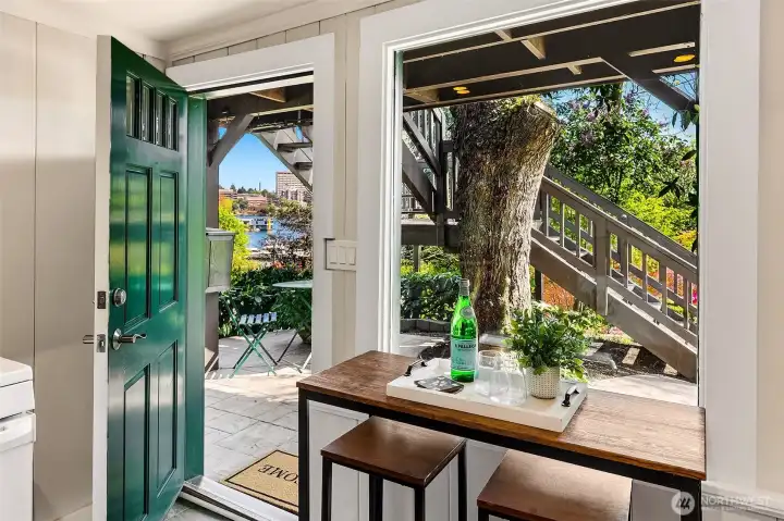 View out from the lower level to the front covered patio and garden views.