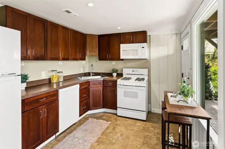 View of the lower level kitchen. To the right, find a nice covered patio.