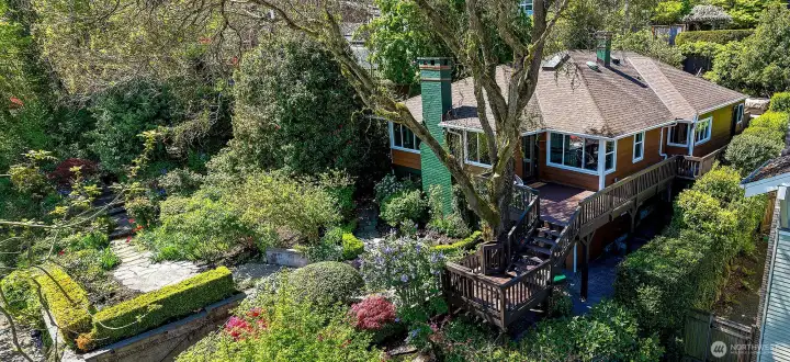 Drone view of the house and the grounds. Perched up and set back for maximum privacy. There are multiple outdoor spaces to enjoy.