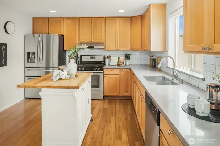 Appointed with solid quartz slab countertops and full-heigh tile backsplash
