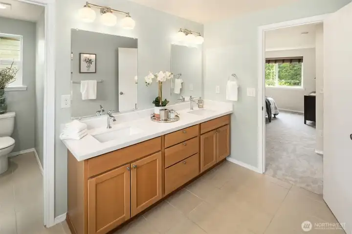 Updated bath with slab quartz and tile flooring, separate water closet