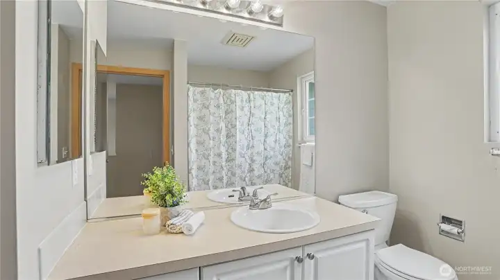 Light-filled upstairs main bathroom featuring a bright, clean, and inviting space