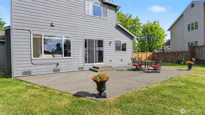 Expansive backyard patio featuring a large concrete slab with hot tub wiring—ready for your ultimate outdoor relaxation retreat