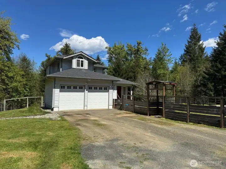 A fully fenced yard with fruit trees and garden beds accompany the entrance to your home.