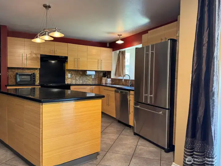 Custom bamboo cabinets, Corian countertops and cork backsplash make this kitchen a joy to cook and entertain in.