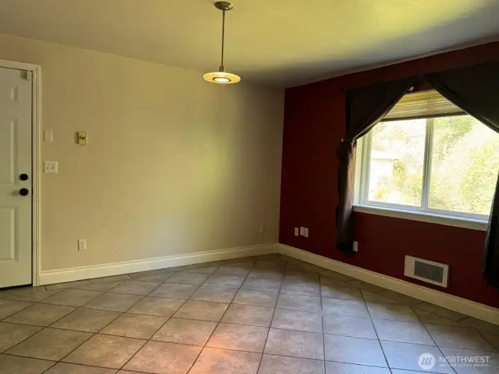 This dining area makes it easy to engage with family and friends in the kitchen. The door leads to the garage.