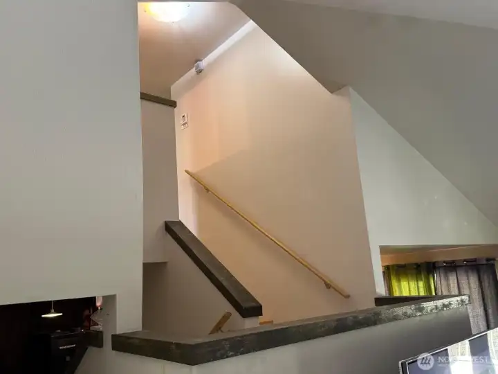 The open stairwell adds to the spacious feeling in the living room.