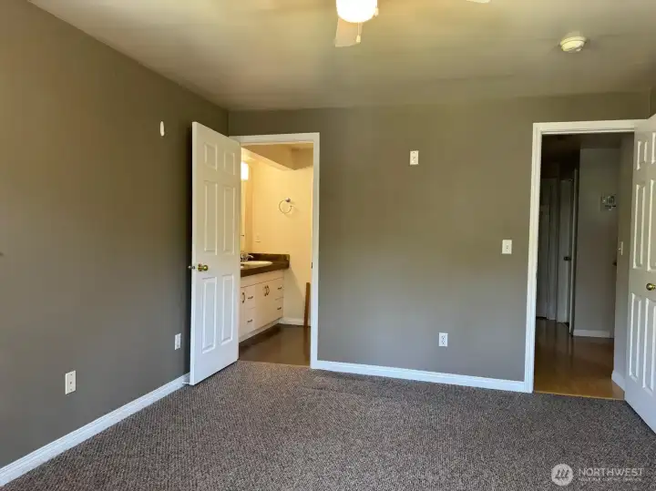 The accompanying bathroom suite begins with sinks and a walk in closet.