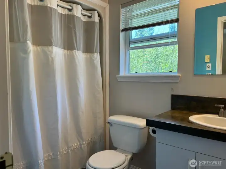 This upstairs bathroom has everything you need, plus a view!