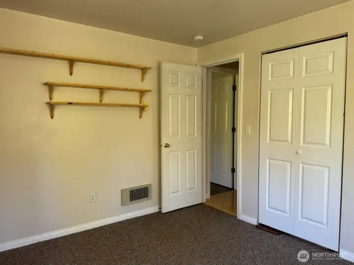 Additional shelving and closet provide plenty of storage options.