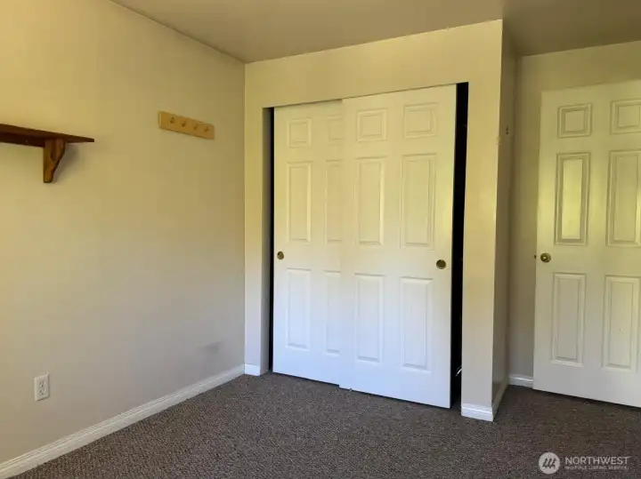 A spacious closet is just what this simple bedroom space needs.