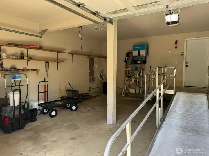 The garage is tall with ample space for cars and storage. The ramp can be removed so that just the landing remains outside the door.