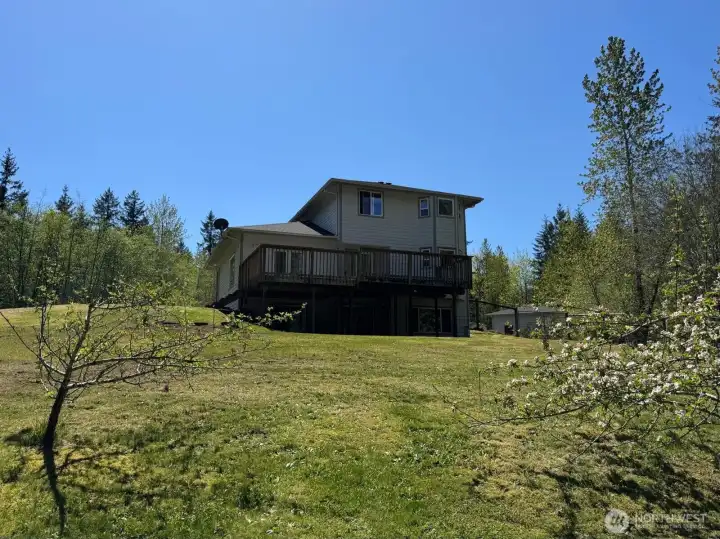 Imagine sitting on the expansive deck and looking down to your own little apple orchard.