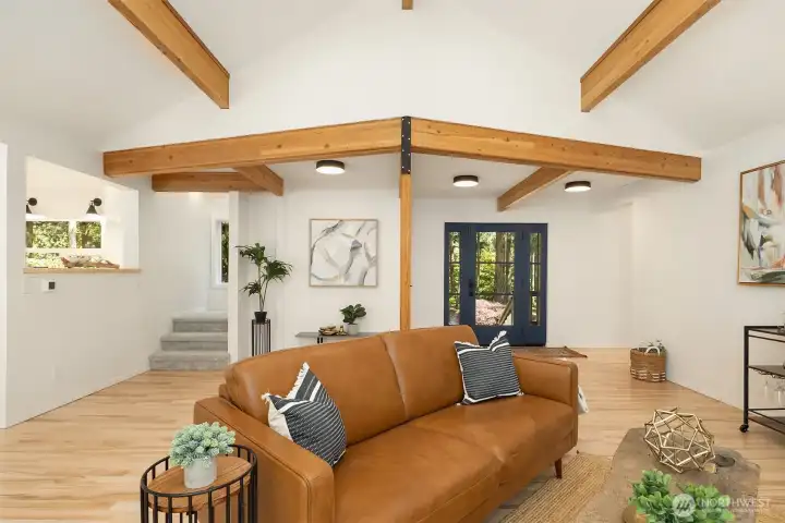 Front Door, Stairs up to Studio Space, Kitchen on the Left, Hallway to the right leading to Primary Suite and Second Bedroom
