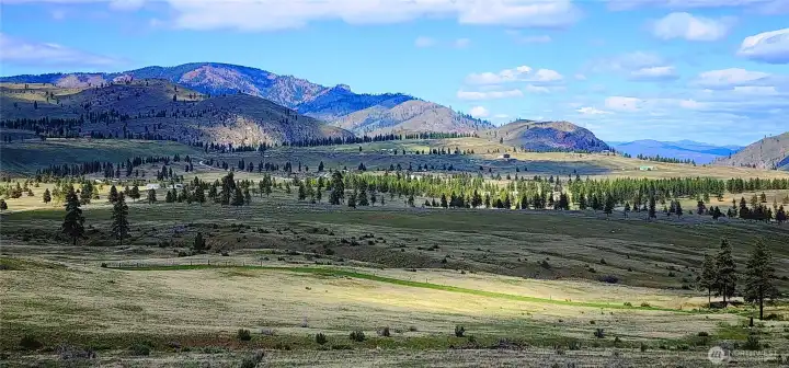 Panoramic mountain views, wide open spaces, and endless recreation await at this stunning Washington Creek 20 acre parcel near Chelan. It doesn't get more serene than this!
