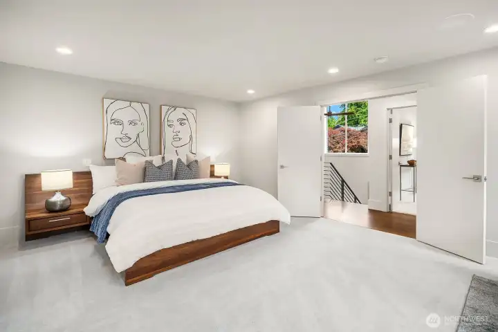 Double doors leading to luxurious upper-level primary suite