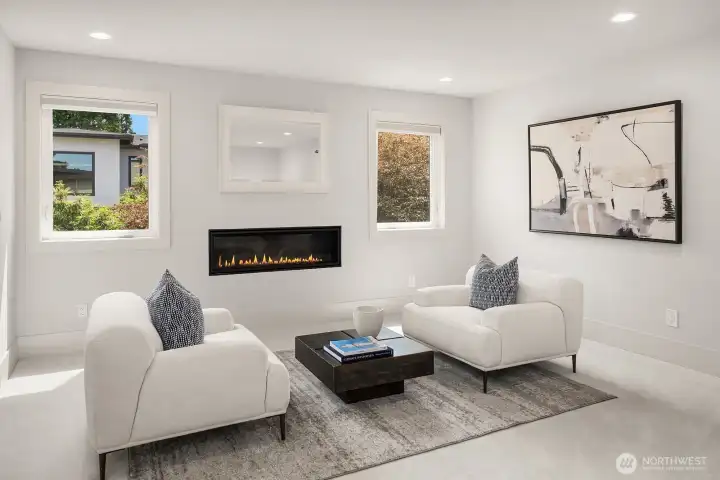 Upper-level primary suite with sitting area and gas fireplace