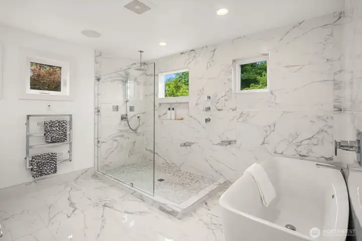 Retreat to the spa-inspired upper-level primary bathroom