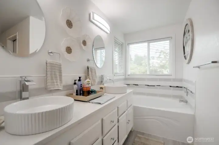 Dual sinks, bathtub and shower.