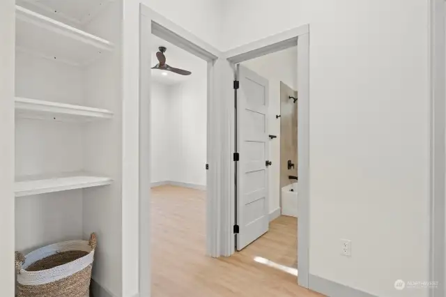 Linen closet and additional storage options in the hallway ensure that every inch of the home is both functional and clutter-free.