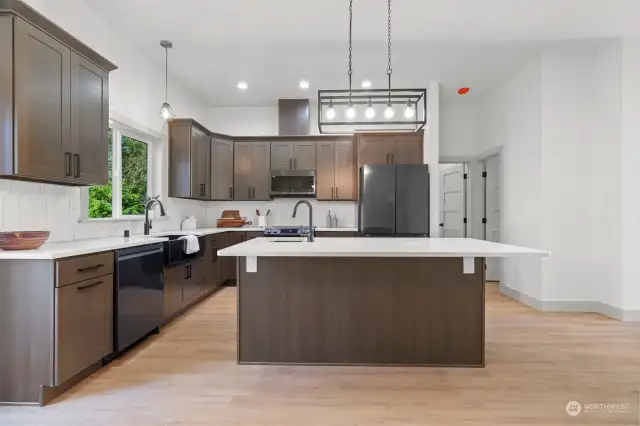 The heart of the home seamlessly transitions into a dining space and a chef's dream kitchen.