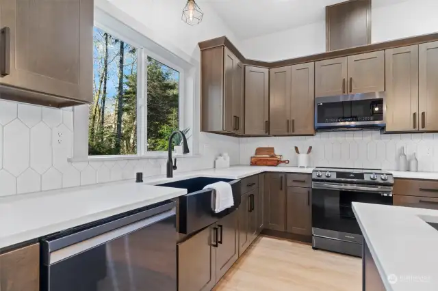 Bright and inviting, it boasts modern appliances nestled amidst sleek countertops and ample cabinetry, providing both form and function in equal measure.