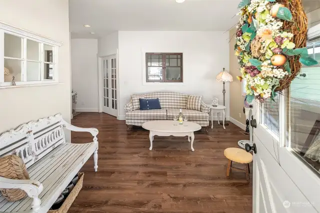 Cute and comfortable living room area off front porch entry.