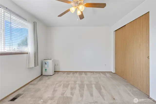 Primary bedroom upstairs with portable air conditioner.