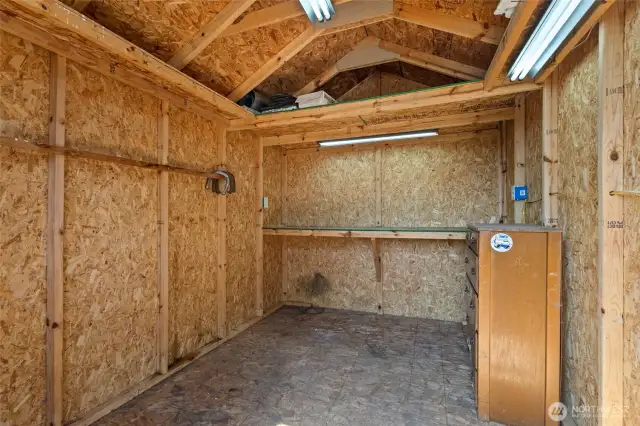 The same layout as the front facing shed. Plenty of room for tools and outdoor equipment, featuring a well lit workbench!
