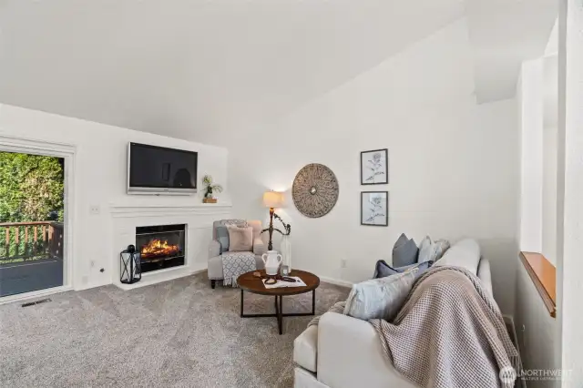 Living room with fireplace and access to rear deck.