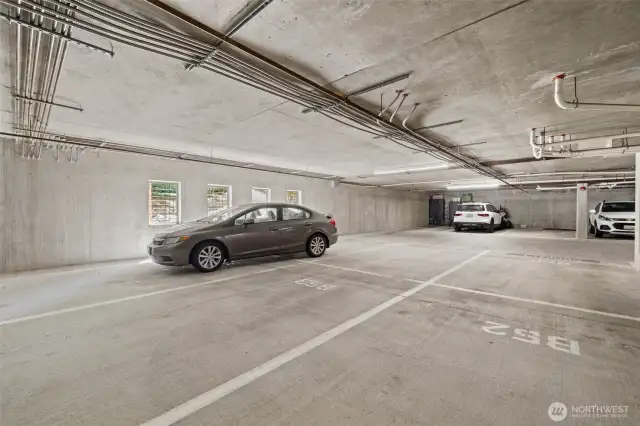 Middle parking tandem spots  is room enough for 2 large cars. This garage is well lite and spacious.