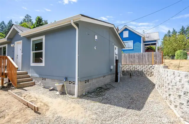 The front and side yards feature beautiful terracing.