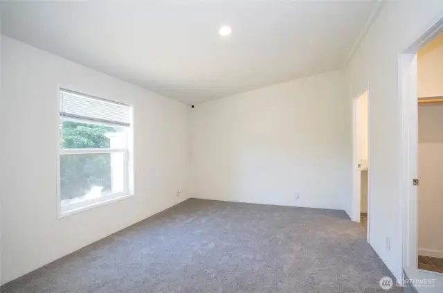 Bright and inviting primary suite, enhanced with fresh new carpeting.
