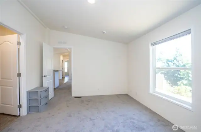 The primary suite features a huge picture window, with new carpeting throughout the home.