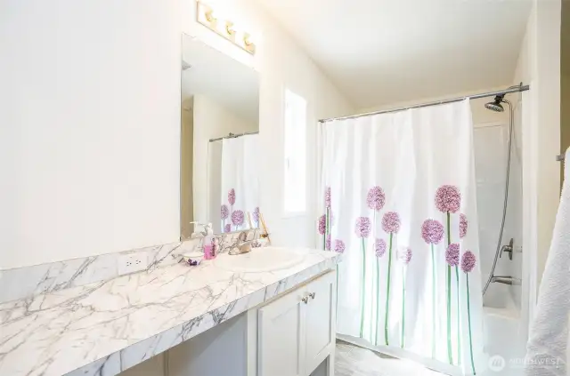 Private primary ensuite with generous counter space for added convenience.