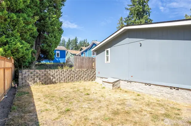 Another view of the backyard with a nice terrace wall providing separation from the neighbor.