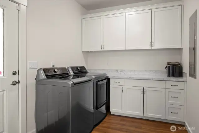 Utility room off the kitchen provides ample workspace.