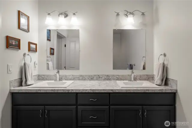 Through the walk-in closet, an ensuite bathroom provides everything you need for discrete living downstairs.