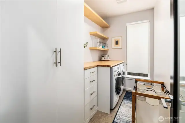 Built ins, shelves, and butcher block counter added to the laundry room