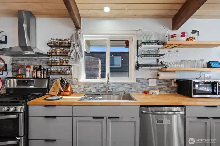 Enjoy cooking in this updated kitchen featuring a workstation kitchen sink and pot filler at the stove area.