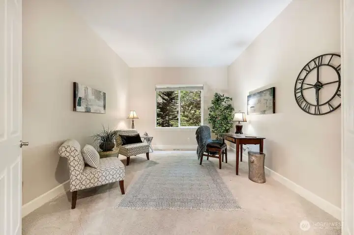 This versatile space can be your den or home office, featuring a window with serene views of the outdoors—perfectly adaptable to your needs.