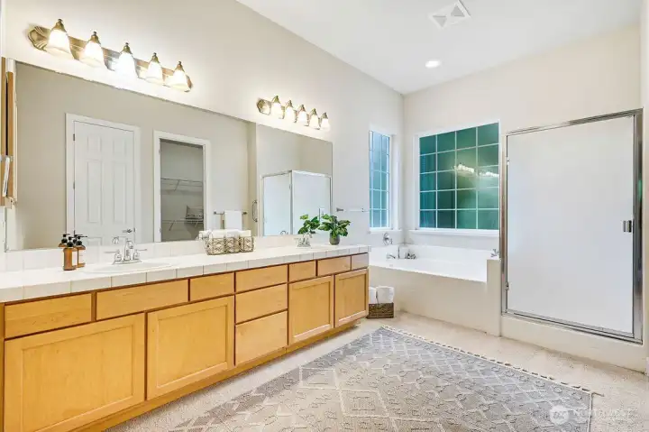 The lovely ensuite features a sunken bathtub for relaxing soaks, a walk-in shower, and double sinks for convenience. Enjoy privacy, a huge walk-in closet, and an additional linen closet for all your towels, sheets, and essentials.