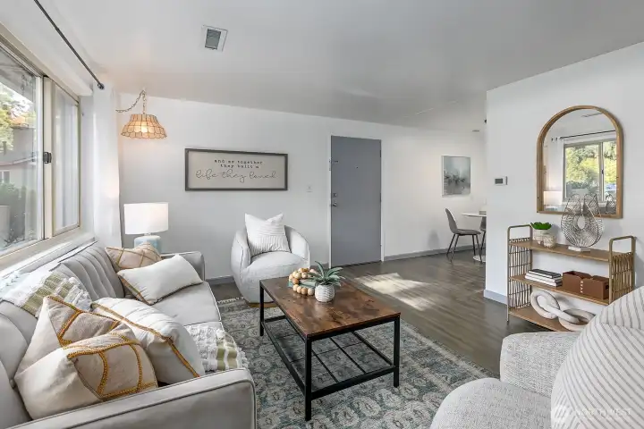 Living area with large picture window, each bedroom has ample closet space and natural light.