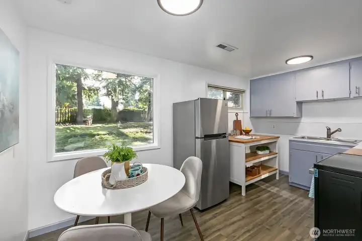 Updated eat-in kitchen with washer/dryer hookups, newer appliances, new picture window and plenty of cabinet space.