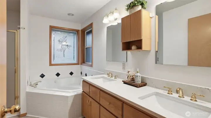 Primary suite bathroom with newly updated counters and flooring