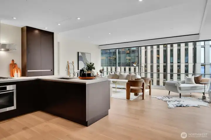 Open concept living as the kitchen opens to the living spaces with city views throughout.