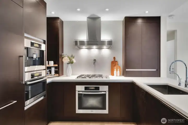 Stone countertops and elegant finishes highlight the kitchen.